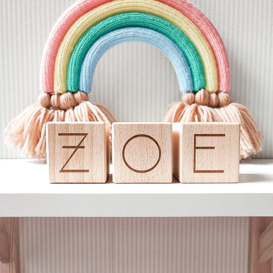 ZOE baby name letters modern style engraved on natural beech wood blocks onawhite shelf nextto boho nursery decor